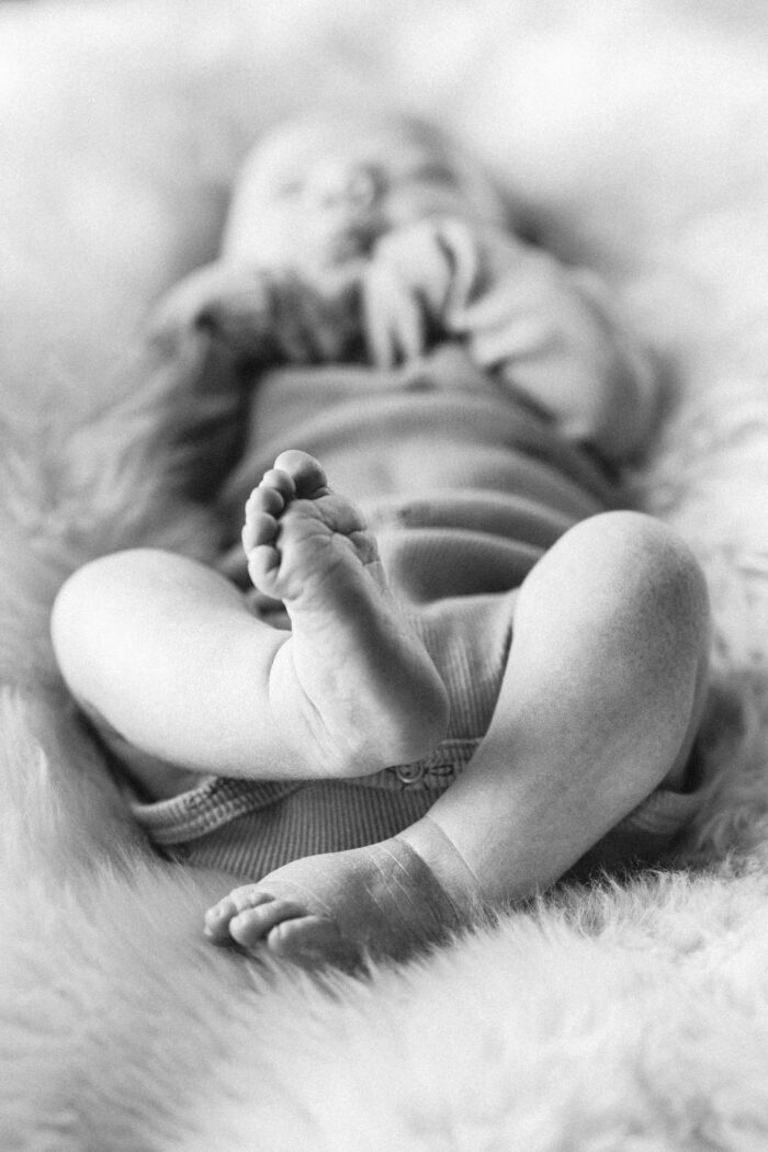 Lifestyle Newborn Photographer in New Hampshire, Boston and New England black and white photo of baby feet